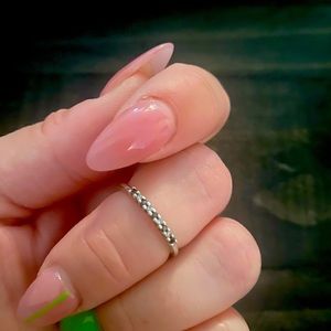 10k white gold band with black and white round diamonds.